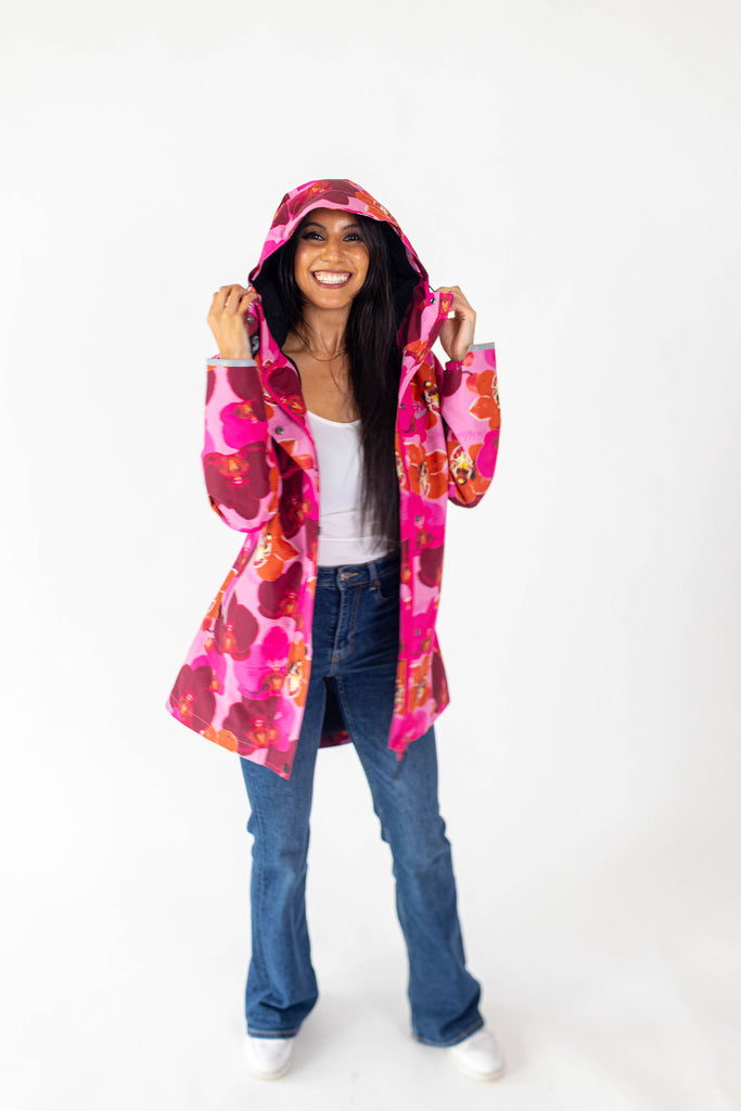 Orquidea Scribbler mesh-lined rain jacket, pink orchid floral print, raincoat, colourful printed rain wear, waterproof jacket for women, lightweight, plus size raincoat, New Zealand design, PFA free, recycled plastic fabrics.