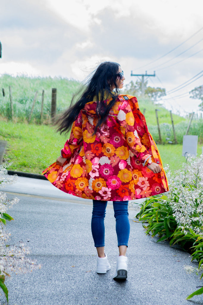 Solar, Scribbler floral rain jacket, yellow rain jacket, pink, orange, white flowers, raincoat, waterproof, plus sizes, New Zealand design, recycled plastic, sustainable fashion, rain gear, outdoor wear for women, rain jacket