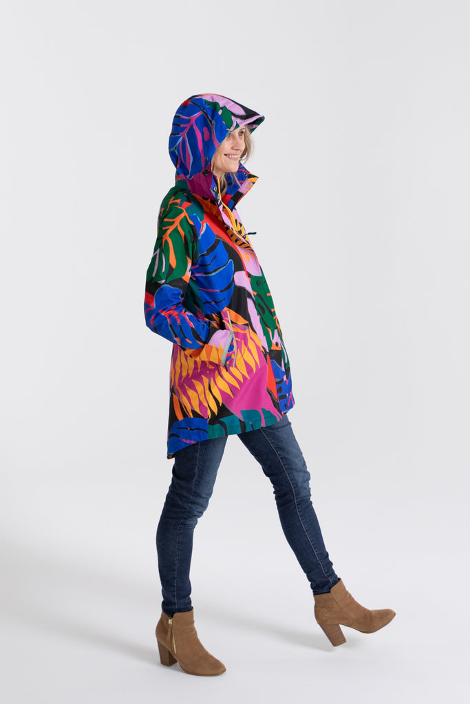 Scribbler rainwear, waterproof raincoat for women, rain jacket for ladies, outerwear, waterproof, mesh lined, lightweight, recycled plastic, sustainable fashion, winter coat, tropical Carnaval print, carnival print, mesh lined, beautiful, colourful print, breathable, packable coat, NZ, New Zealand designer, plus size, curvy, curves, mustard yellow, pink, blue, green