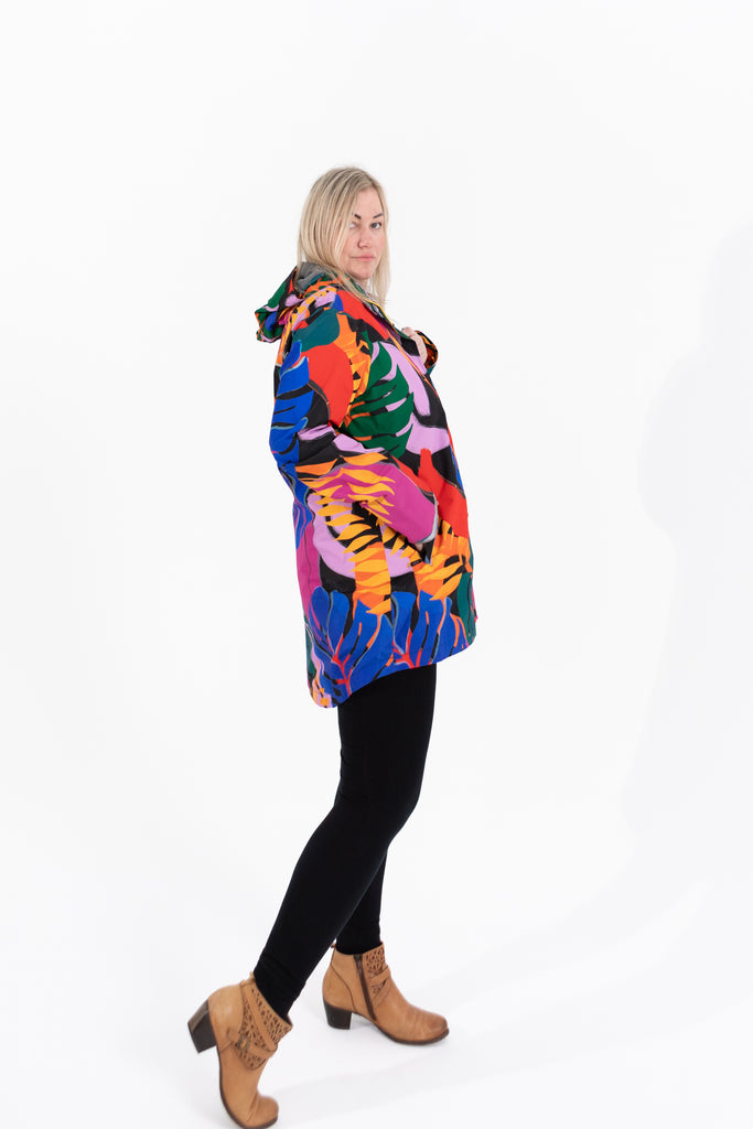Scribbler rainwear, waterproof raincoat for women, rain jacket for ladies, outerwear, waterproof, mesh lined, lightweight, recycled plastic, sustainable fashion, winter coat, tropical Carnaval print, carnival print, mesh lined, beautiful, colourful print, breathable, packable coat, NZ, New Zealand designer, plus size, curvy, curves, mustard yellow, pink, blue, green