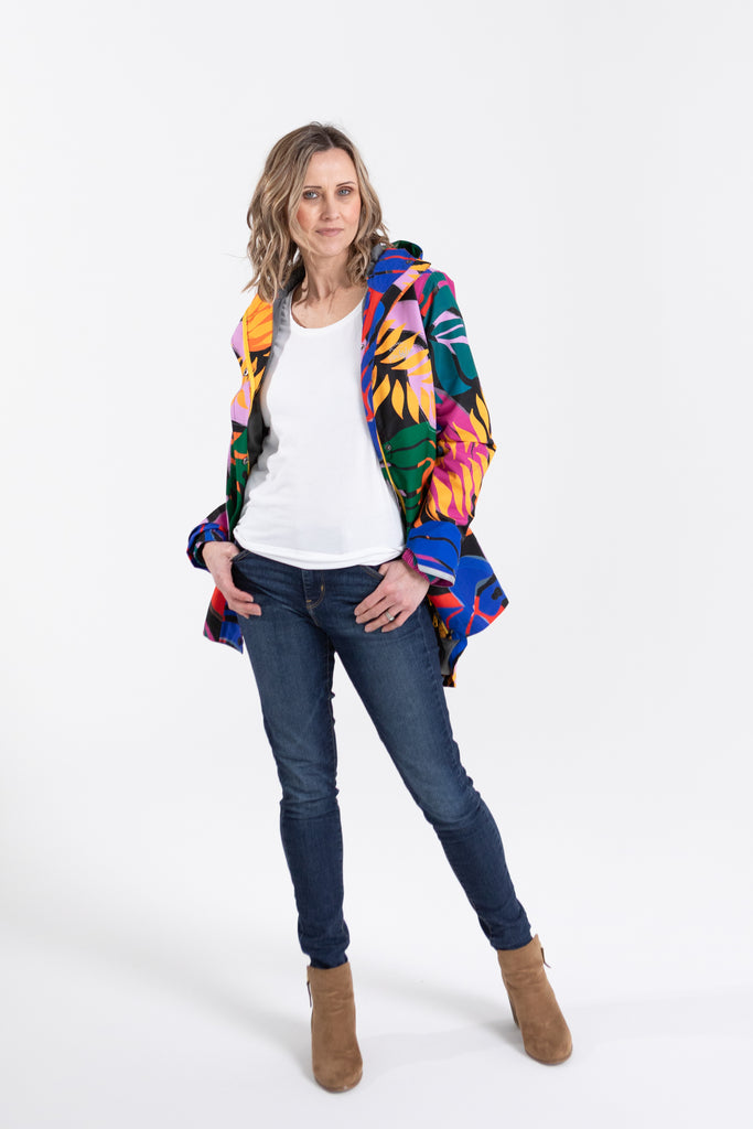 Scribbler rainwear, waterproof raincoat for women, rain jacket for ladies, outerwear, waterproof, mesh lined, lightweight, recycled plastic, sustainable fashion, winter coat, tropical Carnaval print, carnival print, mesh lined, beautiful, colourful print, breathable, packable coat, NZ, New Zealand designer, plus size, curvy, curves, mustard yellow, pink, blue, green