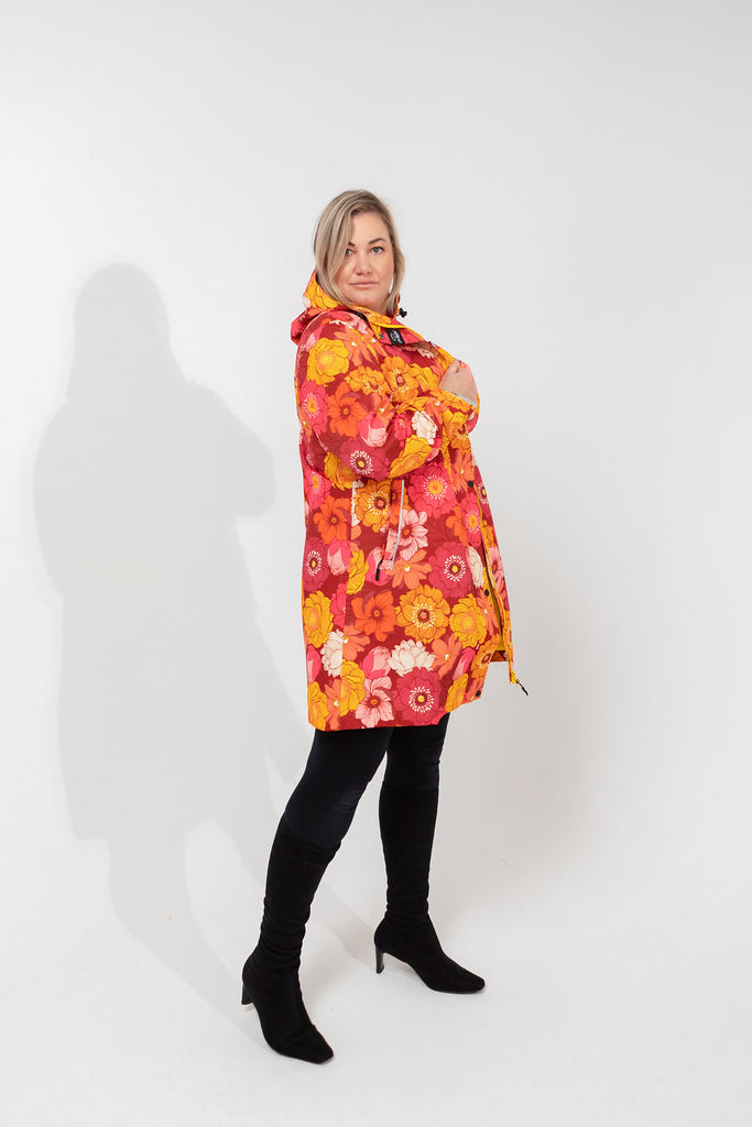 Solar, Scribbler floral rain jacket, yellow rain jacket, pink, orange, white flowers, raincoat, waterproof, plus sizes, New Zealand design, recycled plastic, sustainable fashion, rain gear, outdoor wear for women, rain jacket