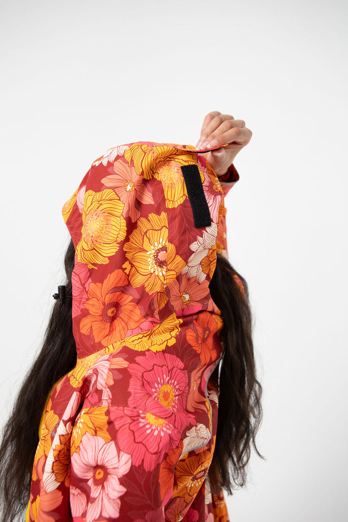 Solar, Scribbler floral rain jacket, yellow rain jacket, pink, orange, white flowers, raincoat, waterproof, plus sizes, New Zealand design, recycled plastic, sustainable fashion, rain gear, outdoor wear for women, rain jacket