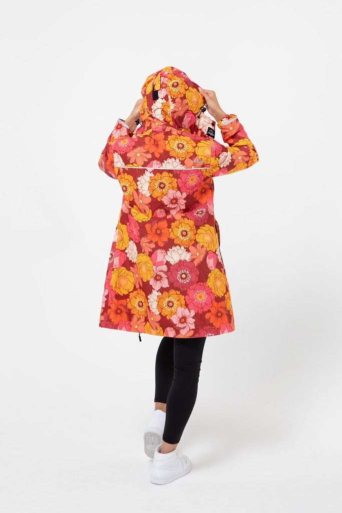 Solar, Scribbler floral rain jacket, yellow rain jacket, pink, orange, white flowers, raincoat, waterproof, plus sizes, New Zealand design, recycled plastic, sustainable fashion, rain gear, outdoor wear for women, rain jacket