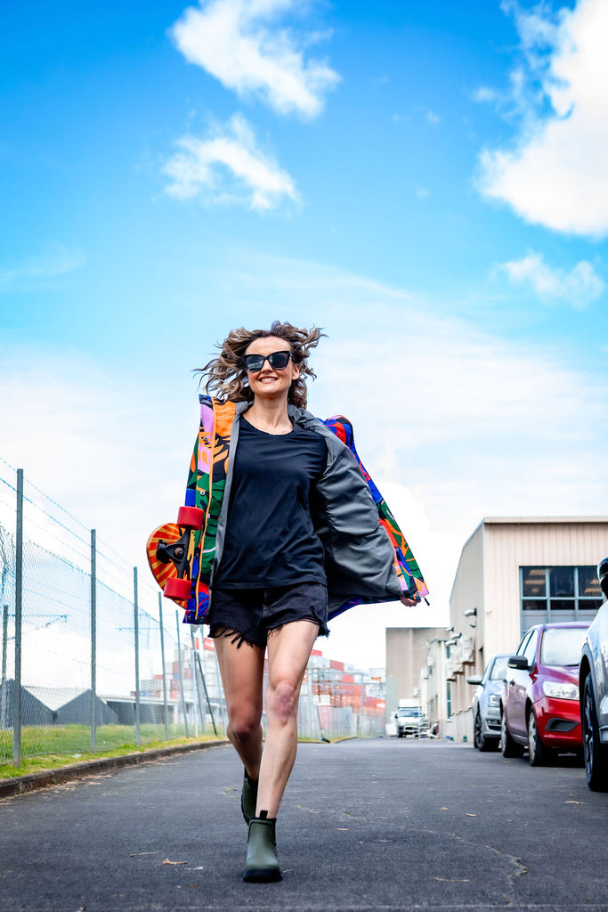 Scribbler rainwear, waterproof raincoat for women, rain jacket for ladies, outerwear, waterproof, mesh lined, lightweight, recycled plastic, sustainable fashion, winter coat, tropical Carnaval print, carnival print, mesh lined, beautiful, colourful print, breathable, packable coat, NZ, New Zealand designer, plus size, curvy, curves, mustard yellow, pink, blue, green