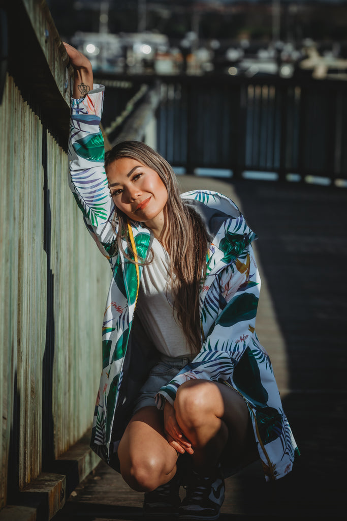 Scribbler rainwear, waterproof raincoat for women, rain jacket for ladies, outerwear, waterproof, mesh lined, lightweight, recycled plastic, sustainable fashion, winter coat, tropical Tropic print, mesh lined, beautiful, colourful print, breathable, packable coat, NZ, New Zealand designer, plus size, curvy, curves, white, green leaves, strelitzia, colourful rain jacket