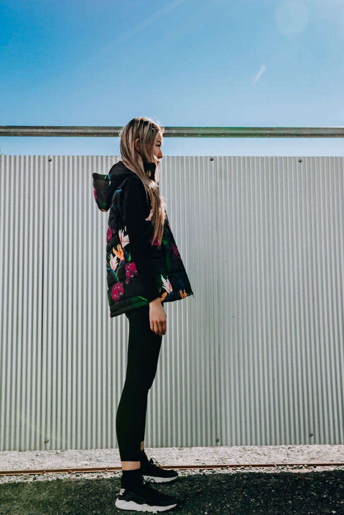 Scribbler paradiso vest, tropical print, black colourful puffer vest, waterproof gilet, recycled fabric, recycled puffer, conscious fashion, plus size vest, floral vest, removable hood, tropical print, printed vest, colourful vest, black puffer vest, quilted vest, plus size vest, NZ, New Zealand, Australia, USA