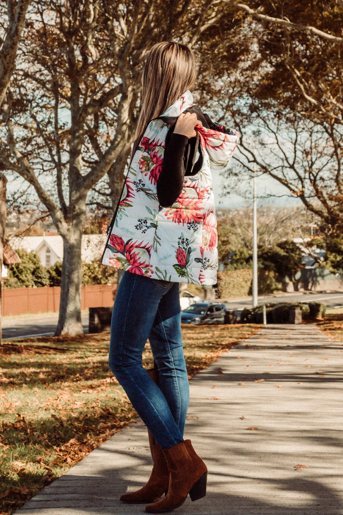 Scribbler protea vest, African protea print, White puffer vest, waterproof gilet, recycled fabric, recycled puffer, conscious fashion, plus size vest, floral vest, removable hood, botanical print, quilted vest, plus size vest, NZ, New Zealand, Australia, USA