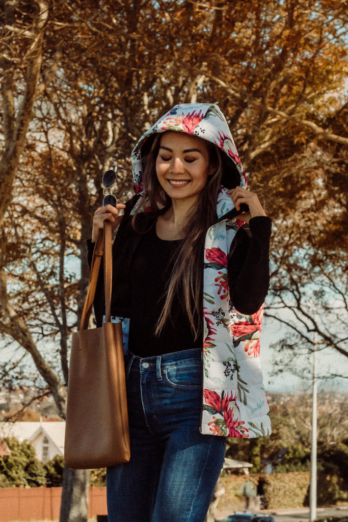 Scribbler protea vest, African protea print, White puffer vest, waterproof gilet, recycled fabric, recycled puffer, conscious fashion, plus size vest, floral vest, removable hood, botanical print, quilted vest, plus size vest, NZ, New Zealand, Australia, USA