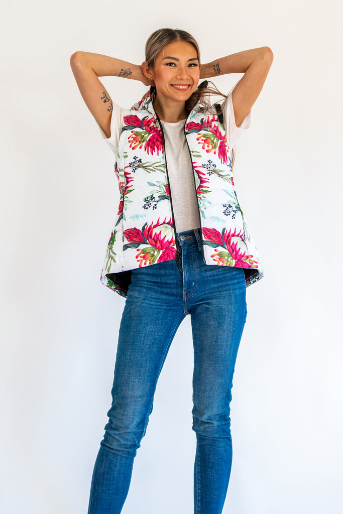 Scribbler protea vest, African protea print, White puffer vest, waterproof gilet, recycled fabric, recycled puffer, conscious fashion, plus size vest, floral vest, removable hood, botanical print, quilted vest, plus size vest, NZ, New Zealand, Australia, USA