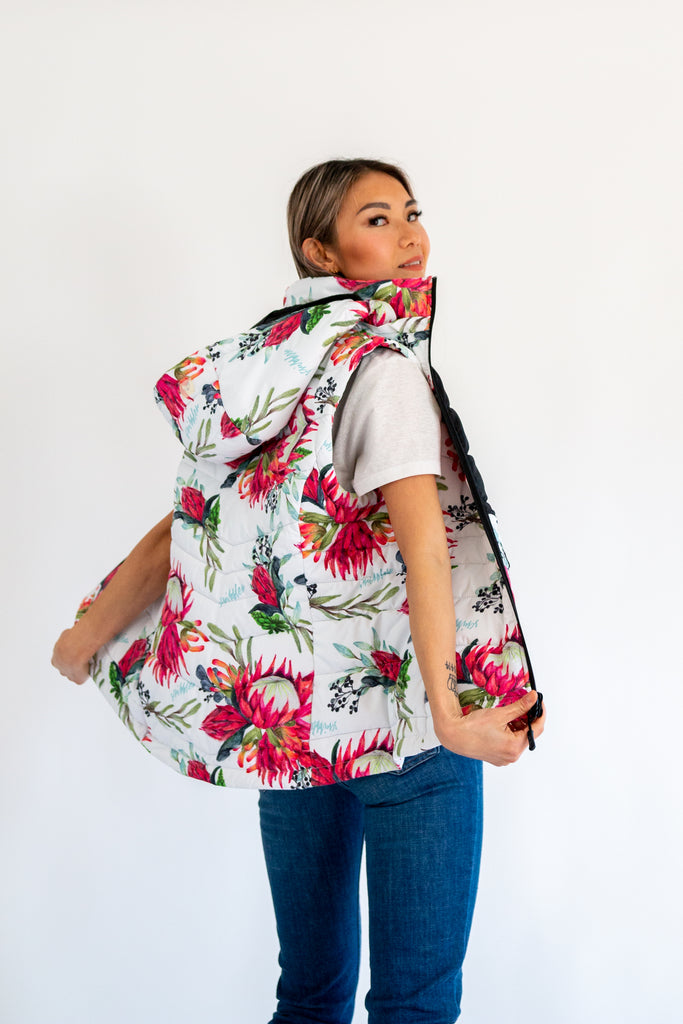Scribbler protea vest, African protea print, White puffer vest, waterproof gilet, recycled fabric, recycled puffer, conscious fashion, plus size vest, floral vest, removable hood, botanical print, quilted vest, plus size vest, NZ, New Zealand, Australia, USA