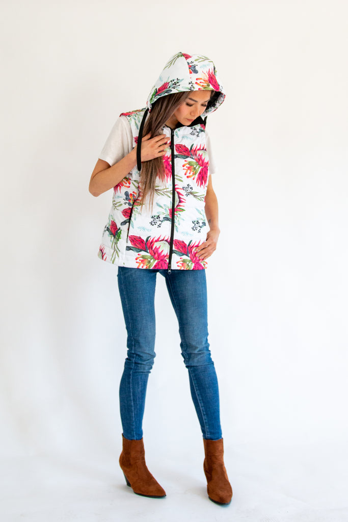 Scribbler protea vest, African protea print, White puffer vest, waterproof gilet, recycled fabric, recycled puffer, conscious fashion, plus size vest, floral vest, removable hood, botanical print, printed vest, colourful vest, quilted vest, plus size vest, NZ, New Zealand, Australia, USA