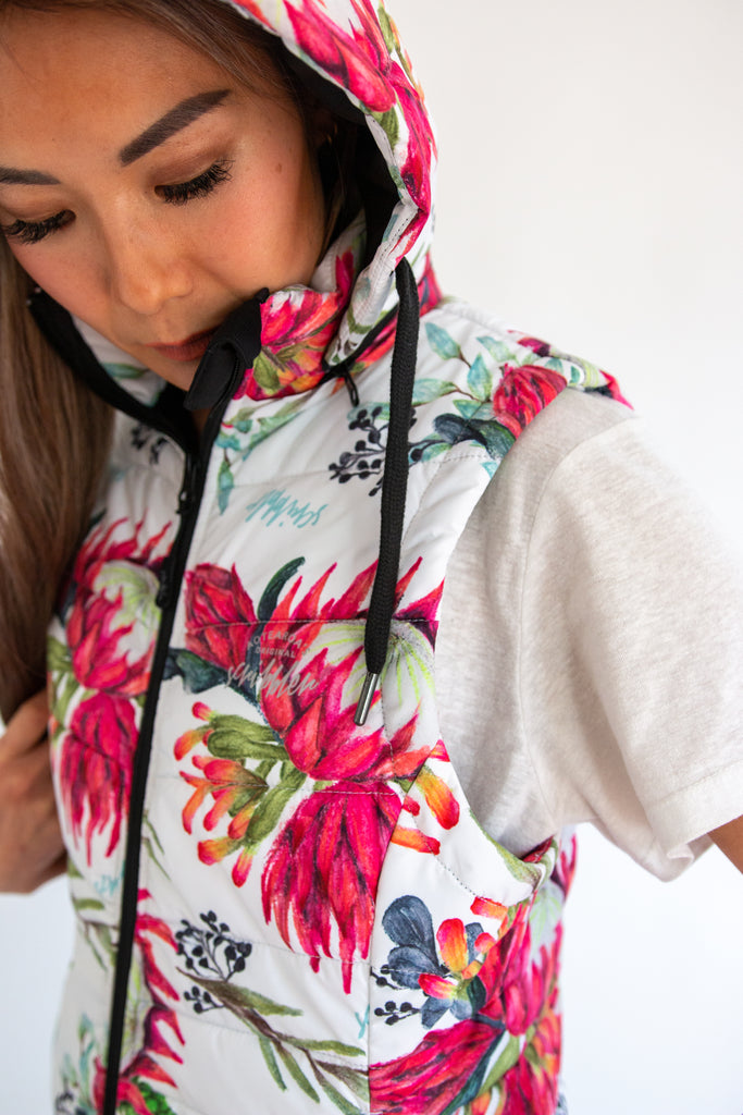 Scribbler protea vest, African protea print, White puffer vest, waterproof gilet, recycled fabric, recycled puffer, conscious fashion, plus size vest, floral vest, removable hood, botanical print, quilted vest, plus size vest, NZ, New Zealand, Australia, USA