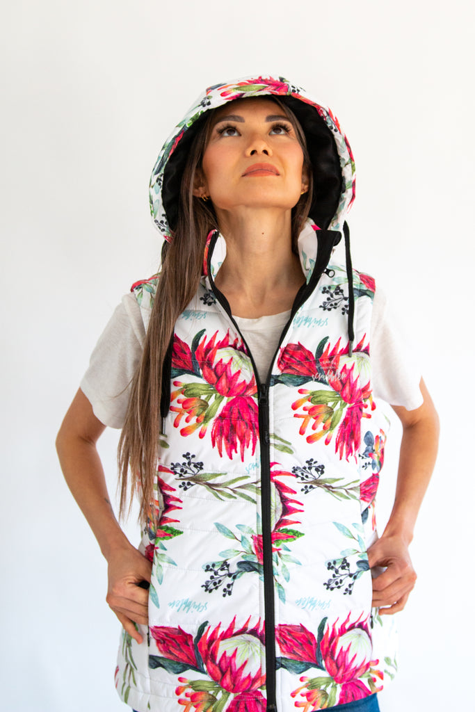 Scribbler protea vest, African protea print, White puffer vest, waterproof gilet, recycled fabric, recycled puffer, conscious fashion, plus size vest, floral vest, removable hood, botanical print, quilted vest, plus size vest, NZ, New Zealand, Australia, USA