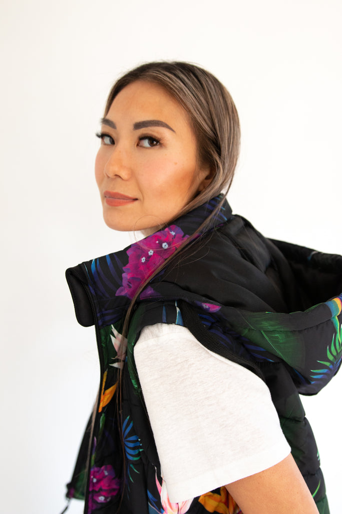 Scribbler paradiso vest, tropical print, black colourful puffer vest, waterproof gilet, recycled fabric, recycled puffer, conscious fashion, plus size vest, floral vest, removable hood, tropical print, printed vest, colourful vest, black puffer vest, quilted vest, plus size vest, NZ, New Zealand, Australia, USA