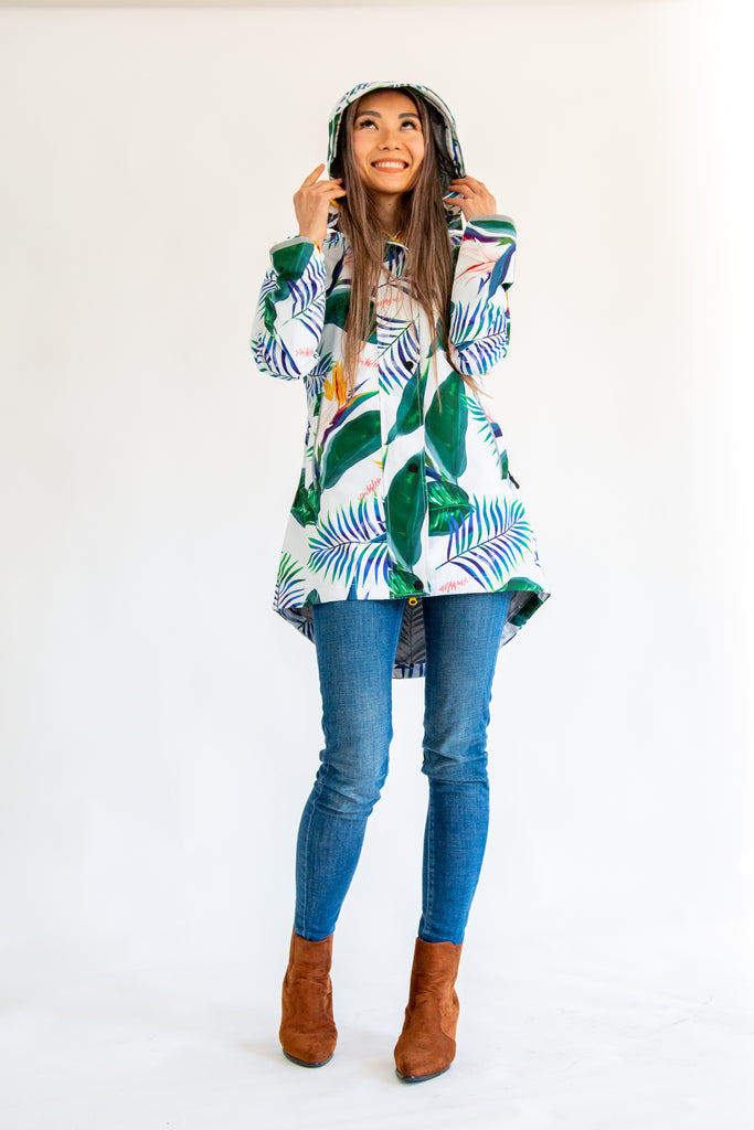 Scribbler rainwear, waterproof raincoat for women, rain jacket for ladies, outerwear, waterproof, mesh lined, lightweight, recycled plastic, sustainable fashion, winter coat, tropical Tropic print, mesh lined, beautiful, colourful print, breathable, packable coat, NZ, New Zealand designer, plus size, curvy, curves, white, green leaves, strelitzia, colourful rain jacket