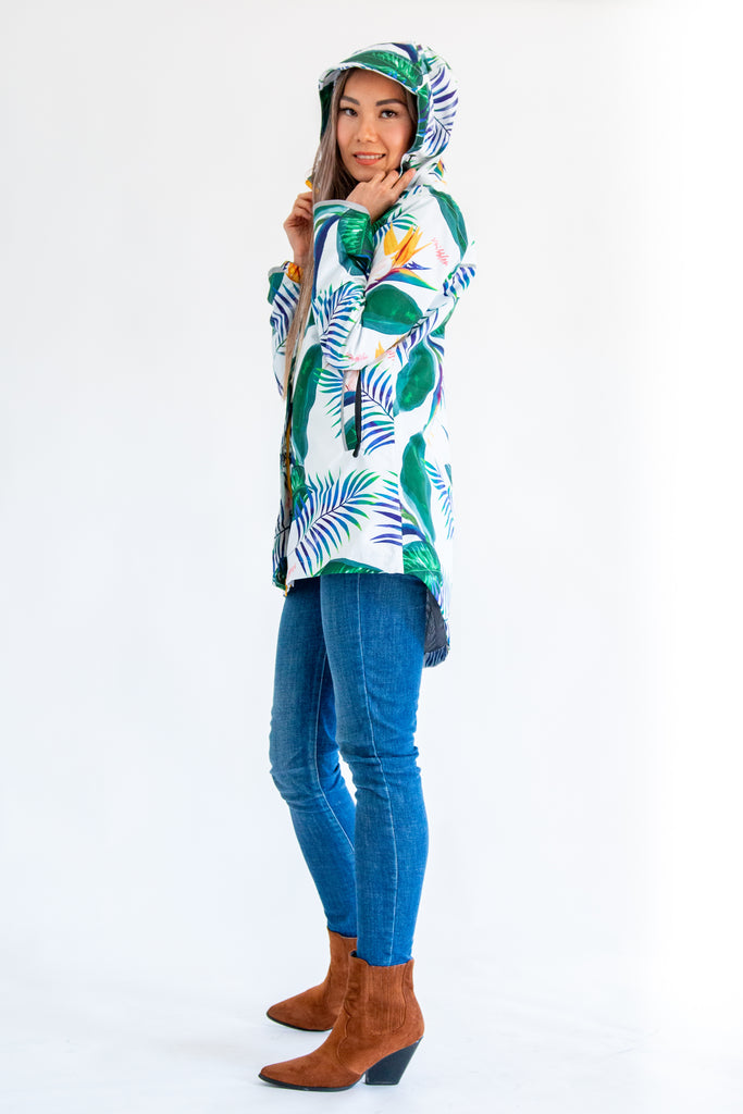 Scribbler rainwear, waterproof raincoat for women, rain jacket for ladies, outerwear, waterproof, mesh lined, lightweight, recycled plastic, sustainable fashion, winter coat, tropical Tropic print, mesh lined, beautiful, colourful print, breathable, packable coat, NZ, New Zealand designer, plus size, curvy, curves, white, green leaves, strelitzia, colourful rain jacket