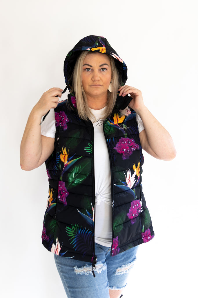 Scribbler paradiso vest, tropical print, black colourful puffer vest, waterproof gilet, recycled fabric, recycled puffer, conscious fashion, plus size vest, floral vest, removable hood, tropical print, printed vest, colourful vest, black puffer vest, quilted vest, plus size vest, NZ, New Zealand, Australia, USA