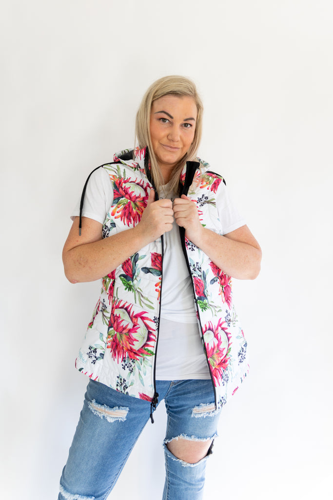 Scribbler protea vest, African protea print, White puffer vest, waterproof gilet, recycled fabric, recycled puffer, conscious fashion, plus size vest, floral vest, removable hood, botanical print, quilted vest, plus size vest, NZ, New Zealand, Australia, USA