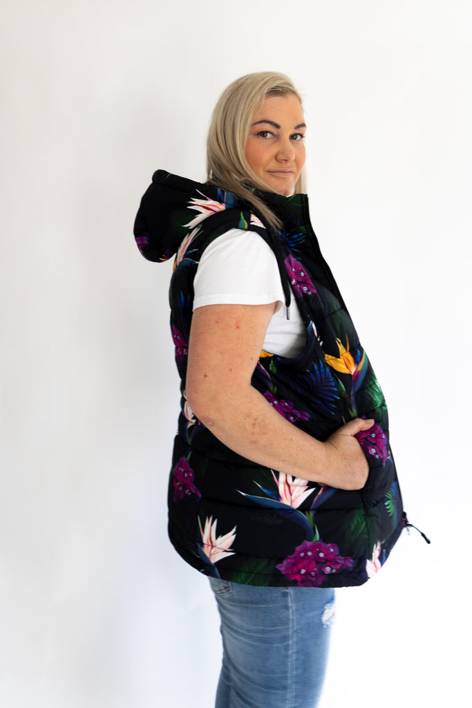 Scribbler paradiso vest, tropical print, black colourful puffer vest, waterproof gilet, recycled fabric, recycled puffer, conscious fashion, plus size vest, floral vest, removable hood, tropical print, printed vest, colourful vest, black puffer vest, quilted vest, plus size vest, NZ, New Zealand, Australia, USA