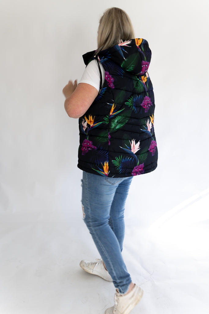 Scribbler paradiso vest, tropical print, black colourful puffer vest, waterproof gilet, recycled fabric, recycled puffer, conscious fashion, plus size vest, floral vest, removable hood, tropical print, printed vest, colourful vest, black puffer vest, quilted vest, plus size vest, NZ, New Zealand, Australia, USA