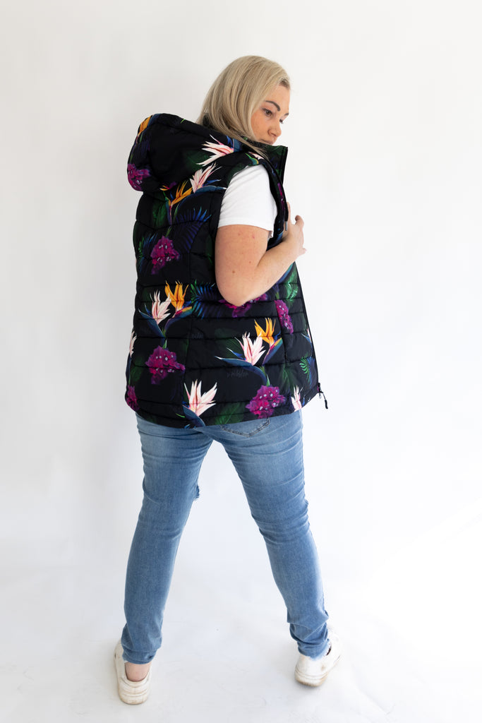 Scribbler paradiso vest, tropical print, black colourful puffer vest, waterproof gilet, recycled fabric, recycled puffer, conscious fashion, plus size vest, floral vest, removable hood, tropical print, printed vest, colourful vest, black puffer vest, quilted vest, plus size vest, NZ, New Zealand, Australia, USA